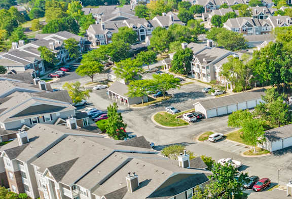A bird's eye view of a residential area with houses and trees.
