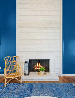 a living room with a fireplace and blue walls