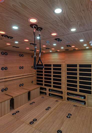 A sauna with wooden benches and a heater.