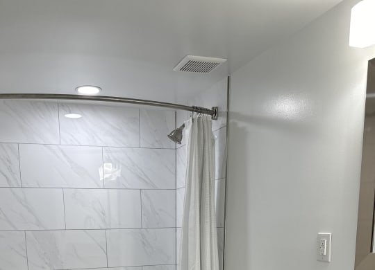 a bathroom with a shower and a toilet in it