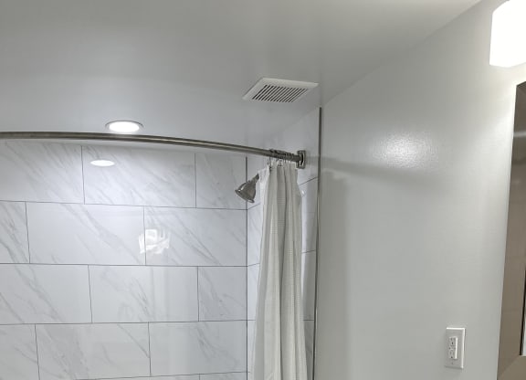 a bathroom with a shower and a toilet in it