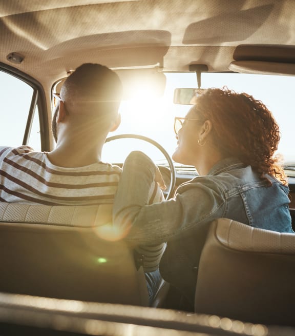 a man and woman sitting in a car looking out the window at North Grove, Riverside, 92501