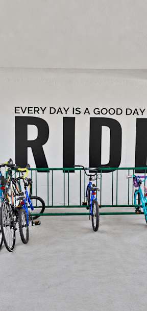 A bike parking area with a sign that says "Every day is a good day to RIDE".
