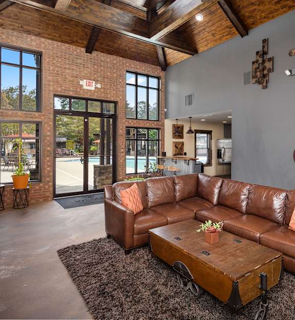 a living room with a leather couch and a coffee table