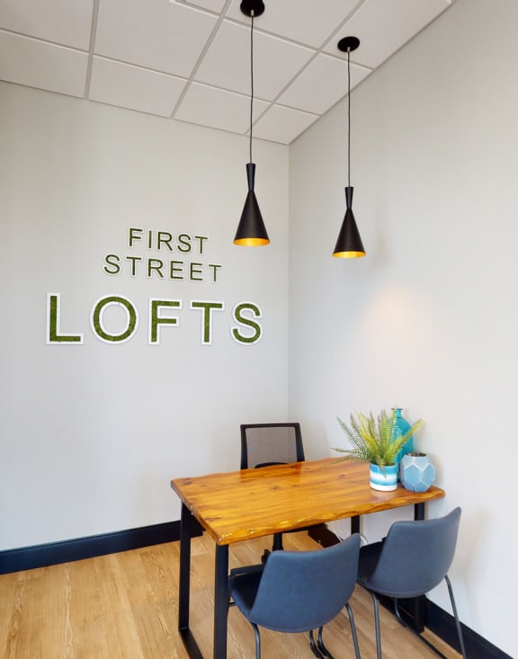 a living room with couches and chairs and a televisionat First Street Lofts in Downtown Bismarck, Bismarck