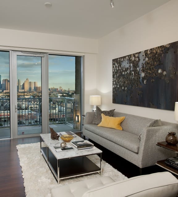 a living room with a large window and a view of the city