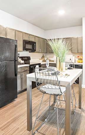 an open kitchen with a granite counter top and stools