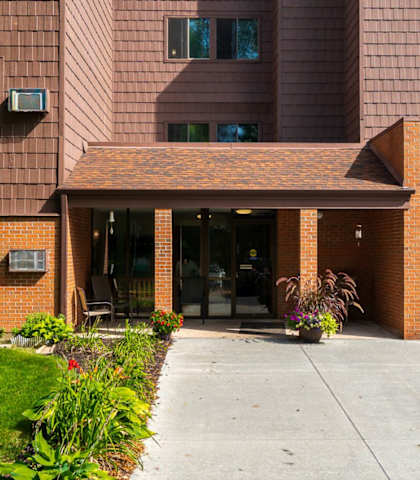 a large brick building with a sidewalk in front of it