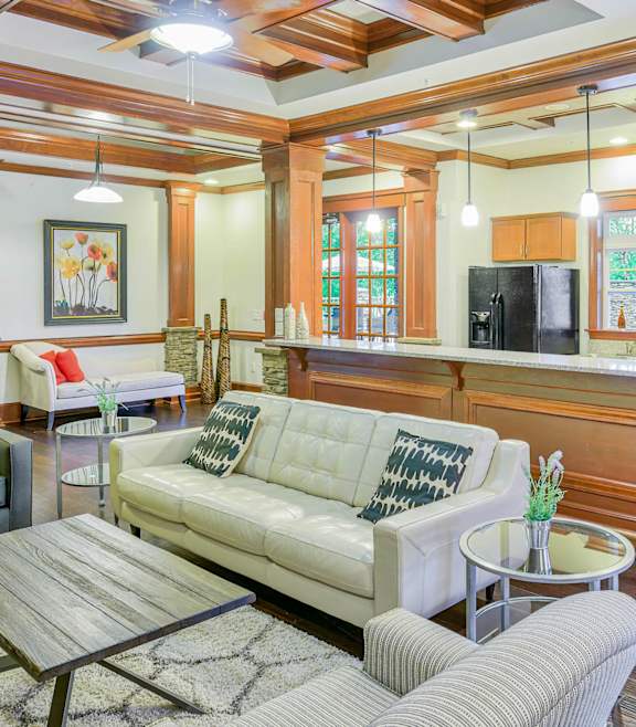 A modern living room with a blue couch and a coffee table. at The Lofts at Reynolds Village Apartments, Asheville