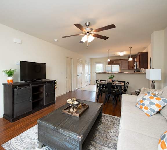 A living room with a television, a couch, and a coffee table.