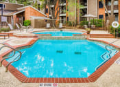 Thumbnail 4 of 31 - Pool area at Village Oaks Apartments, Austin, TX