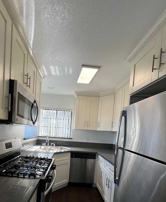 A kitchen with a stove top oven and a microwave.