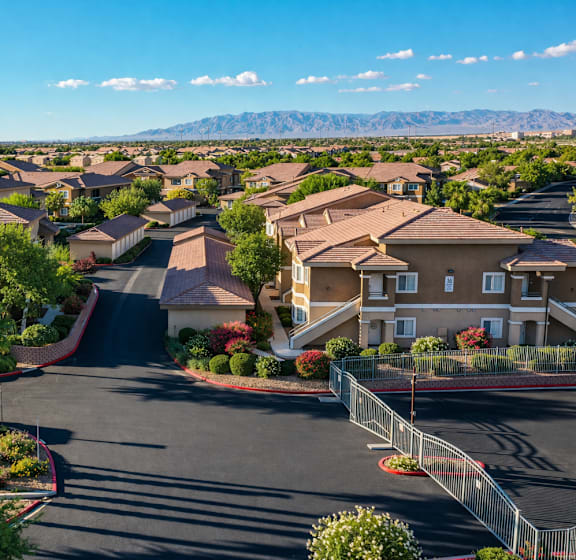A residential area with houses and palm trees.