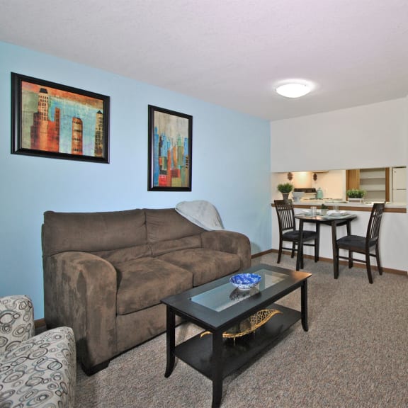 a living room and dining room with a couch and a table