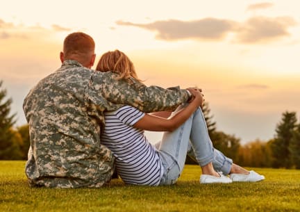 Soldier Sitting on Grass with Wife Admiring Views