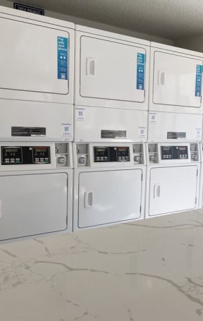 a bunch of white appliances in a room at Latitude Apartments at Mission Valley, San Diego