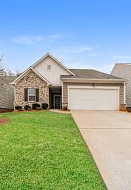 A house with a white garage door and a driveway.