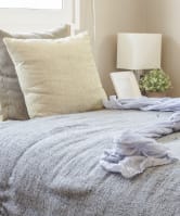 a sofa with white cushions in a living room