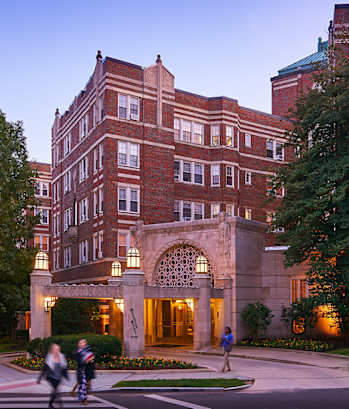 a building on the corner of a city street at dusk