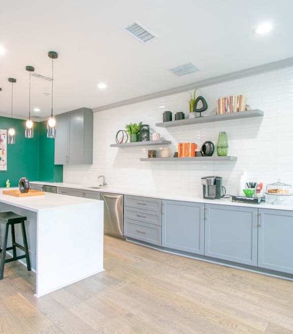 A kitchen with a white island and bar stools at The Atlantic Buckhead Apartments, Atlanta, GA, 30305