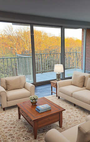 a living room with a green couch and a table at The Langston Views, Washington, DC
