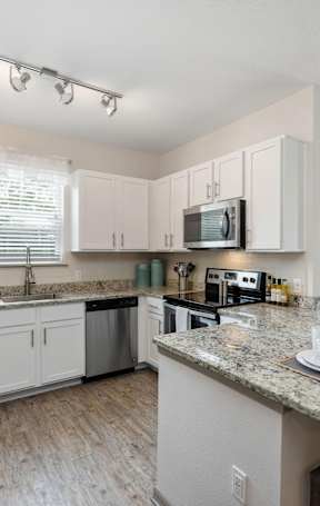 A kitchen with a table set for two.