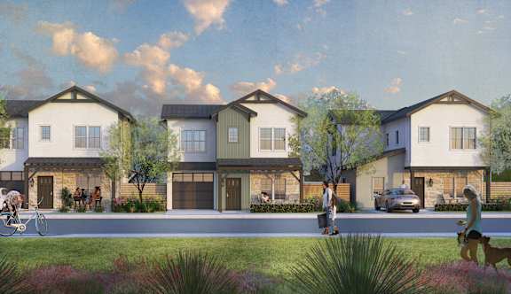 A row of modern houses with people walking and cycling in front.
