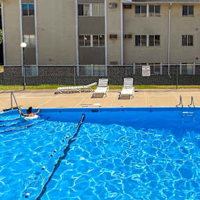 A large blue swimming pool in front of a building at The Ridges Apartments, Iowa, 50315