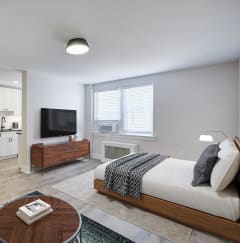 a living room with black furniture and a tv