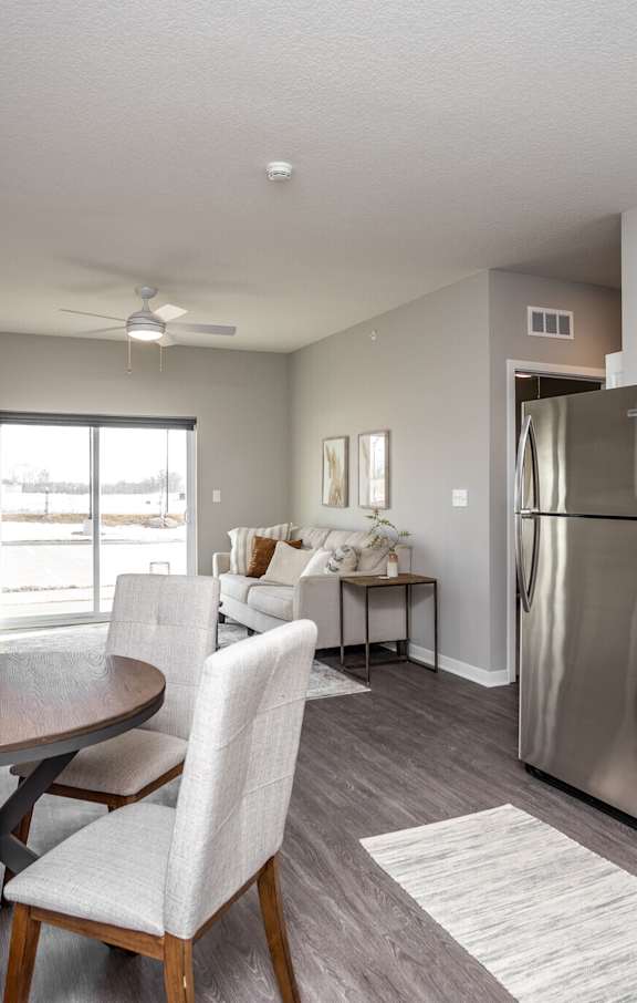A modern kitchen with a table and chairs.