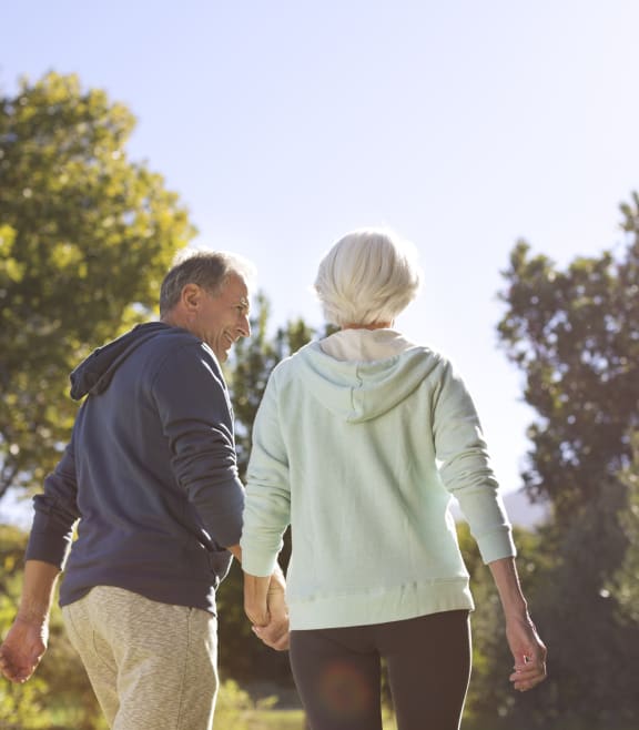 an older couple walking in the park at Estates at Heathbrook, Florida, 34474
