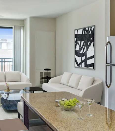 A modern kitchen with a dining table and chairs.