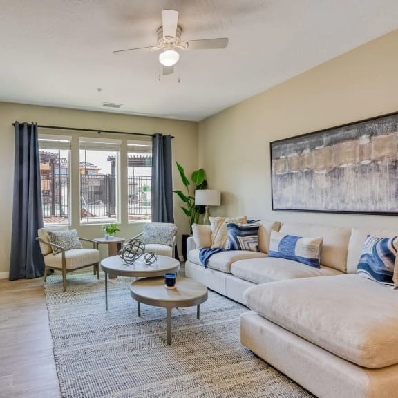 a living room with furniture and a ceiling fan
