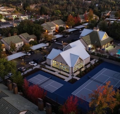 Drone Shot at Dusk with Apartment Roofs, Trees, Pool and Tennis Courtand Roads at Folsom Ranch, Folsom, 95630