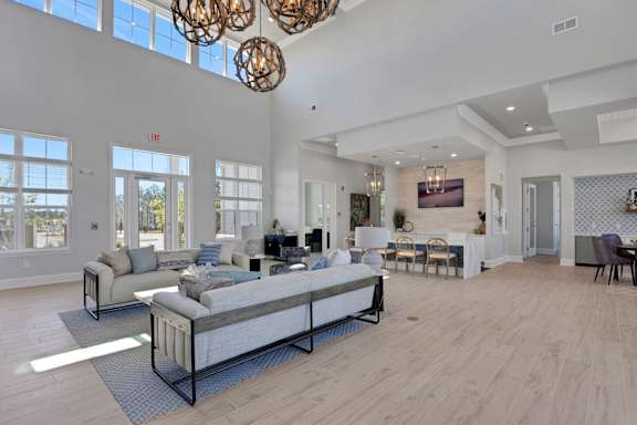 A modern living room with a large sectional sofa and a wooden floor.