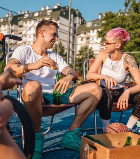 a group of people sitting on a basketball court