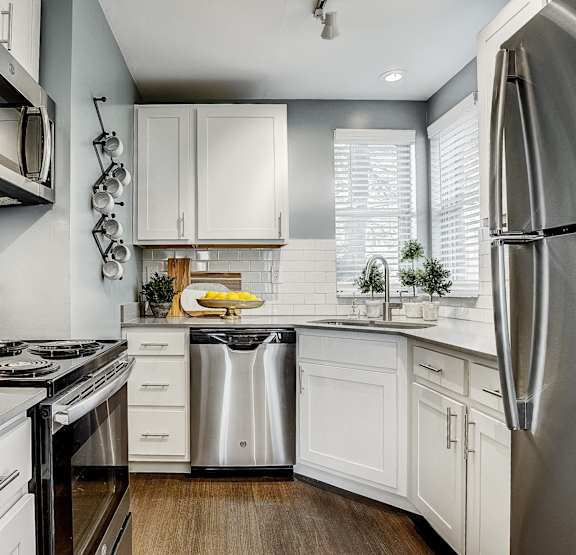 A modern kitchen with white cabinets and stainless appliances. at Mallard Bay Apartments, Crown Point, Indiana, 46307