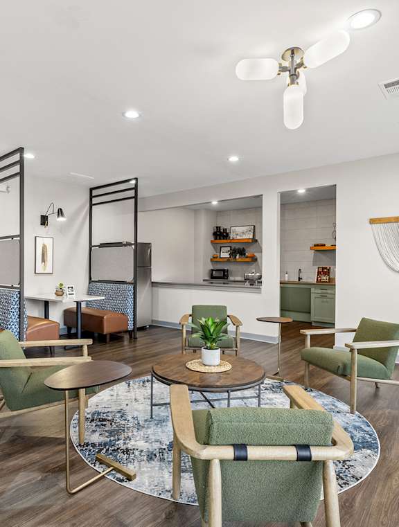A modern dining room with a round table and chairs.
