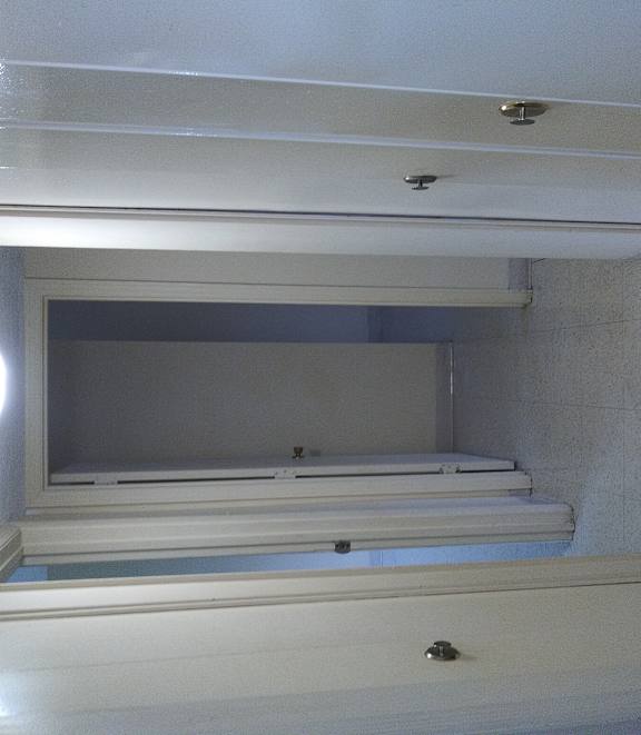 the inside of a bathroom with a sink and a window