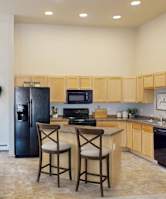 A kitchen with a table and chairs in the middle of the room.