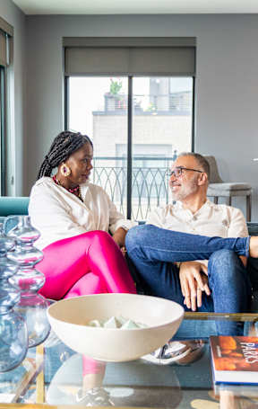 two people sitting on a couch in a living room