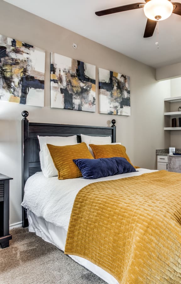 a bedroom with a bed and a ceiling fan at Village of Hawks Creek, Texas