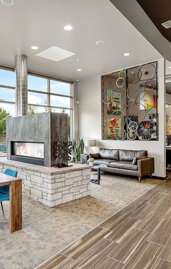 A modern living room with a fireplace and a dining table.