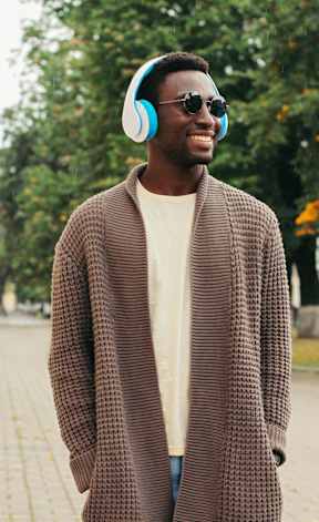 a man wearing headphones walking down the street