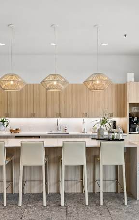 A modern kitchen with a dining table and chairs.