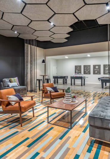 a living room with couches and chairs and a table