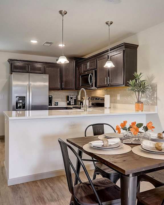 an open kitchen and dining room with a table and chairs