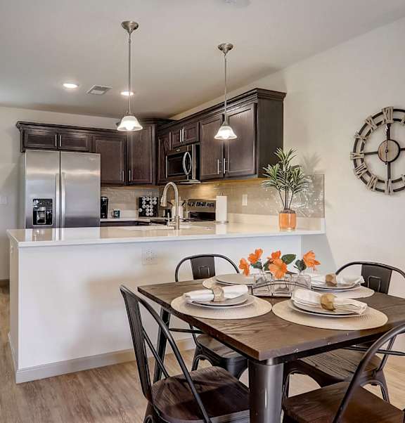 an open kitchen and dining room with a table and chairs