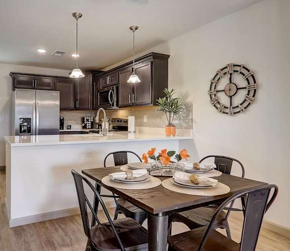 an open kitchen and dining room with a table and chairs