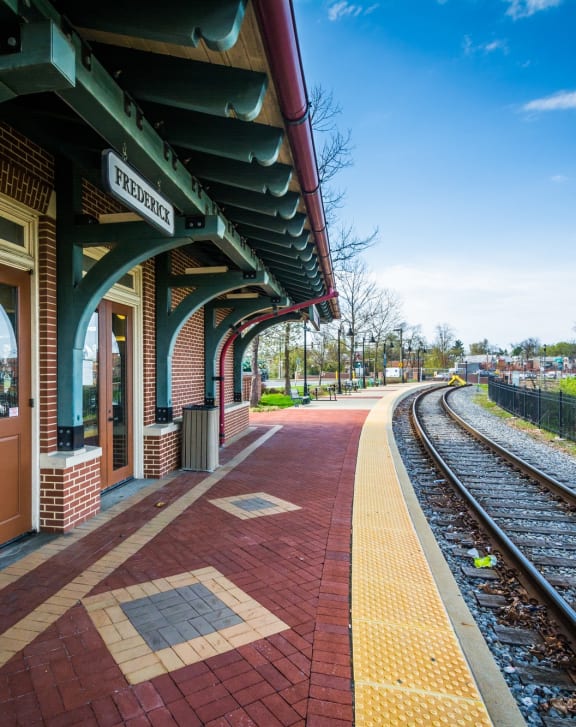 a train station with a platform and train tracks